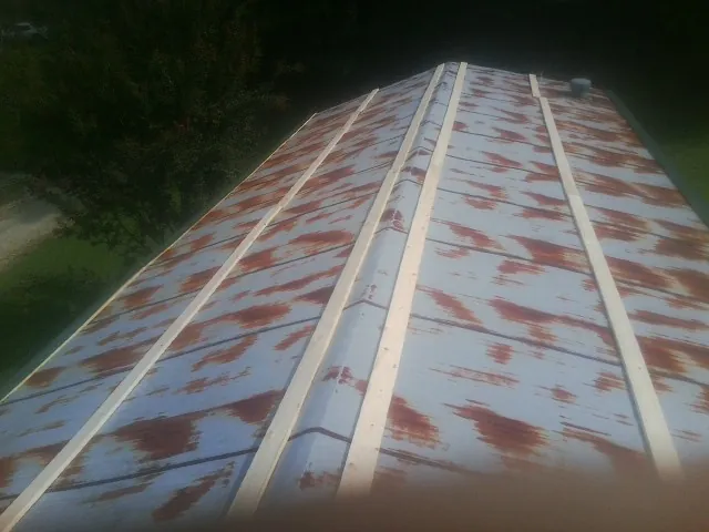 Rusted metal roof panels with new wood purlins before replacement — Storm Damage Roof Repair in Canadensis by Roofing Brothers