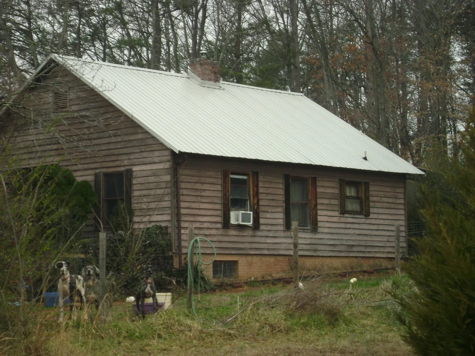White metal roof on an old wood sided farmhouse, from a Metal Roof Installation job in Canadensis